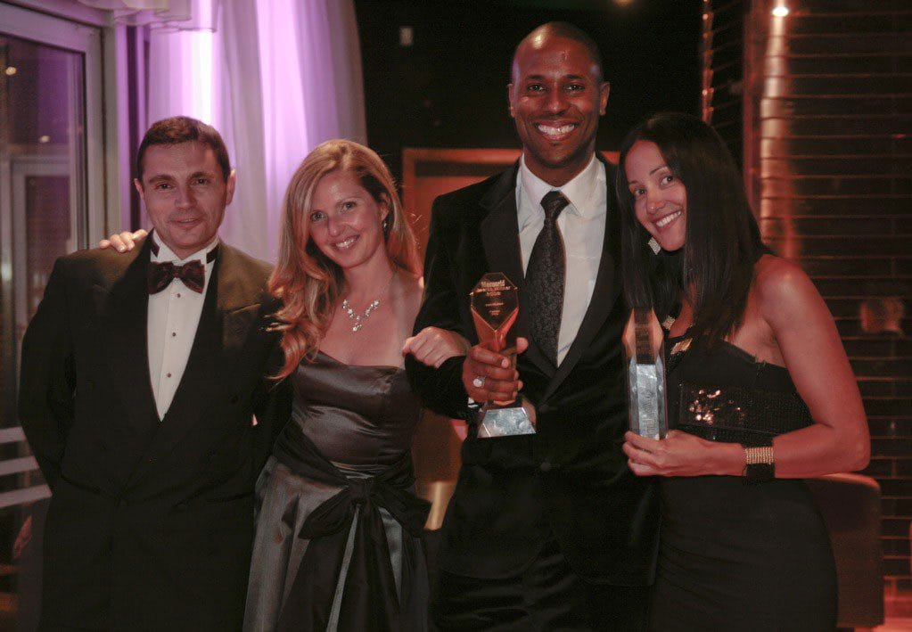 Image of Laban holding award with London Apple head office team Richard West Ingrid Kirschner and Georgina Dias